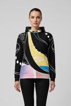 Person wearing a black hoodie with colorful abstract design on a gray background