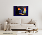A framed wall art print hanging above a light beige sofa in a modern living room. The artwork shows a stylized American flag dress in a dark interior with blue curtains and a sunset scene.