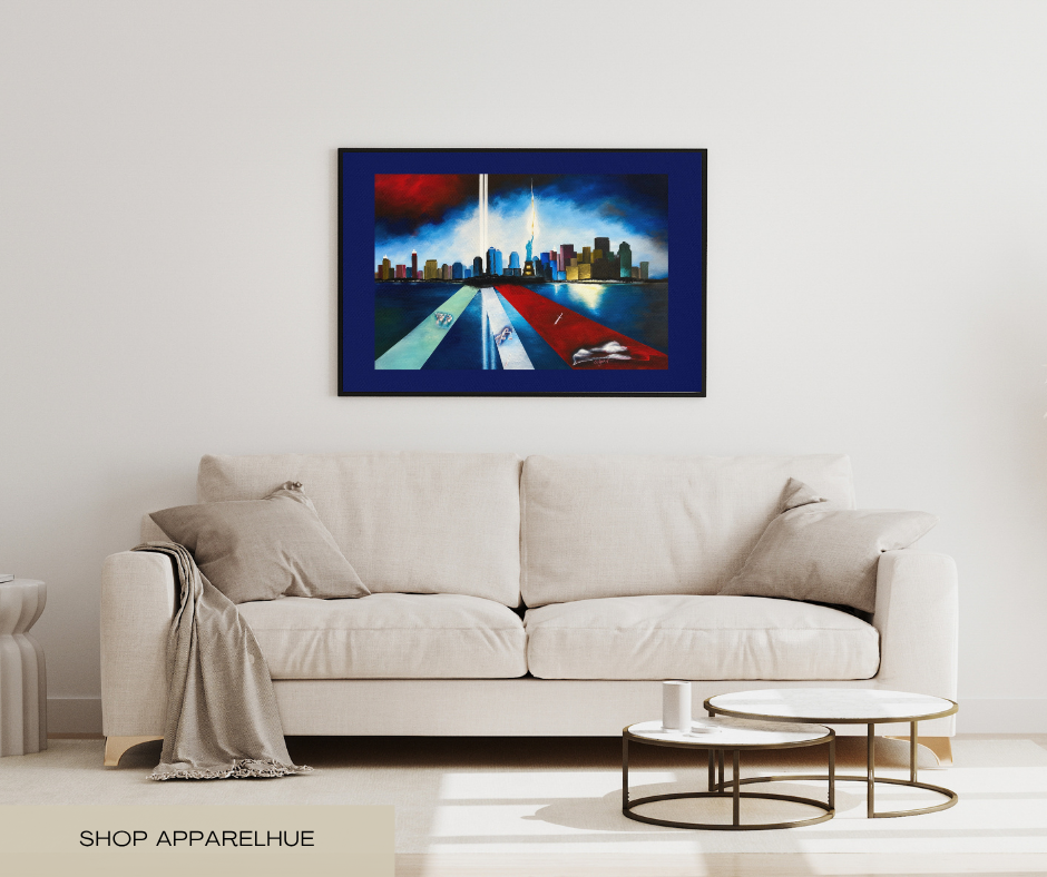 A framed abstract painting of the Twin Towers and city skyline hangs on a white wall above a light beige sofa in a modern living room setting.