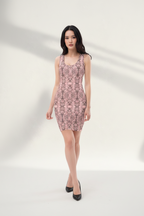 Woman wearing a patterned dress against a neutral background