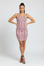 Woman wearing a pink patterned dress on a white background