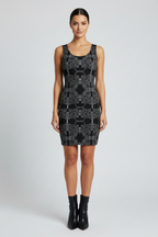Woman wearing a black patterned dress on a white background