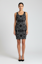 Woman wearing a black and white patterned dress on a white background