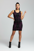 Woman wearing a black dress with purple patterns on a gray background
