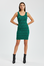 Woman wearing a green patterned dress on a white background