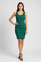 Woman wearing a green patterned dress on a white background