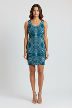 Woman wearing a blue patterned dress on a white background