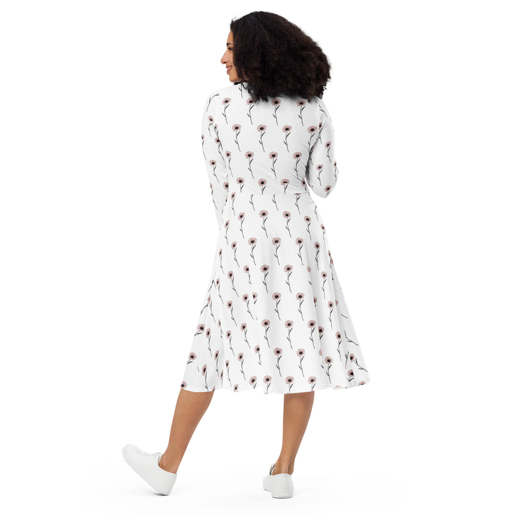 Woman wearing a white dress with a floral pattern on a white background