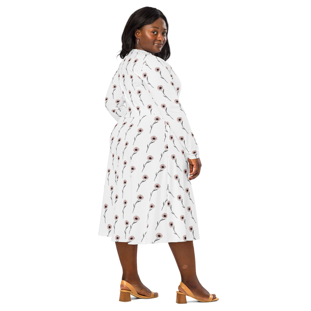 Woman wearing a white dress with red floral pattern on a white background