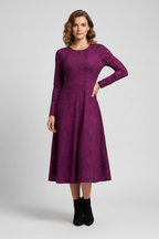 Woman wearing a purple dress with long sleeves on a white background