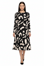 Woman wearing a black and white patterned dress on a white background