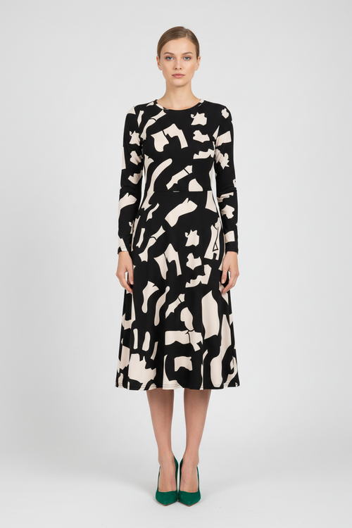 Woman wearing a black and white patterned dress on a white background