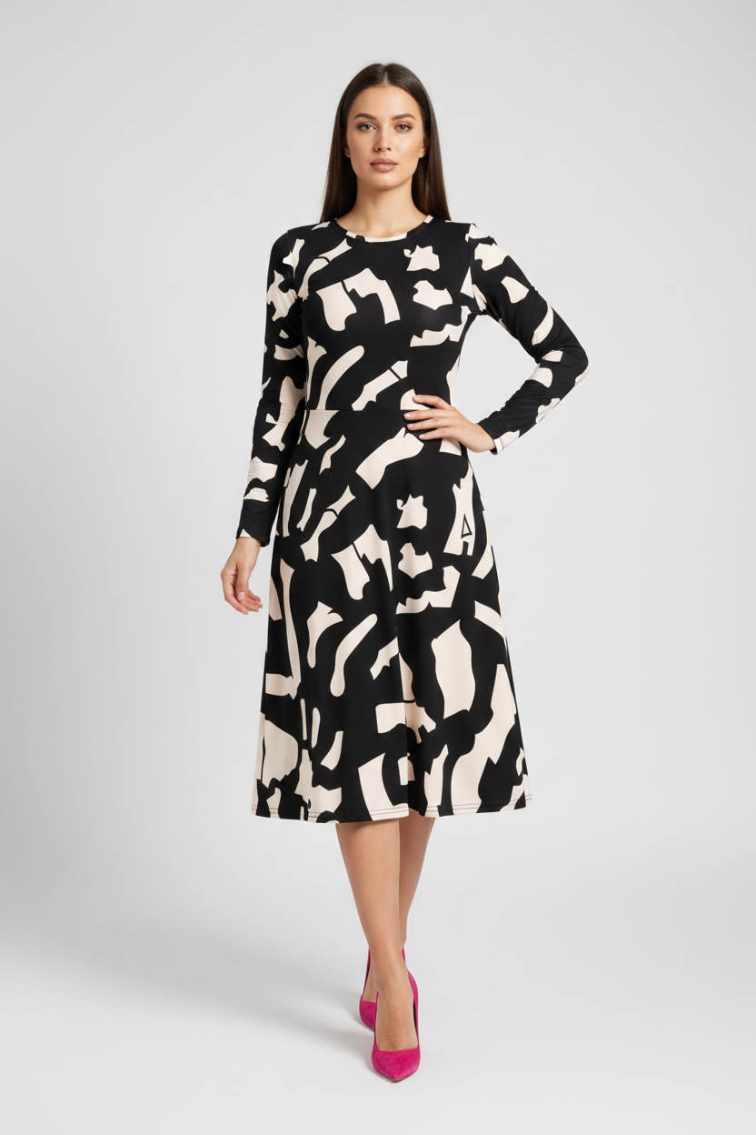 Woman wearing a black and white patterned dress on a gray background
