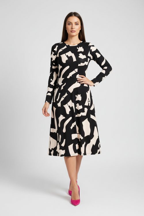 Woman wearing a black and white patterned dress on a gray background