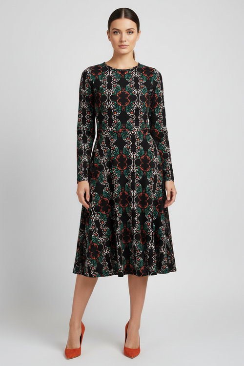 Woman wearing a patterned dress on a plain background