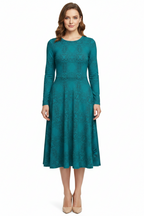 Woman wearing a teal dress on a white background