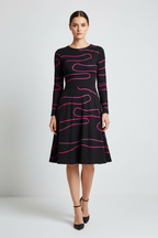 Woman wearing a black dress with pink wavy lines on a white background