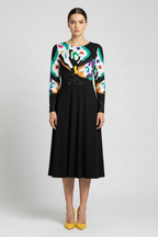 Woman wearing a black dress with colorful abstract patterns on a white background