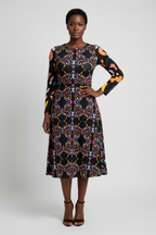 Woman wearing a patterned dress on a white background