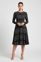 Woman wearing a patterned dress on a white background
