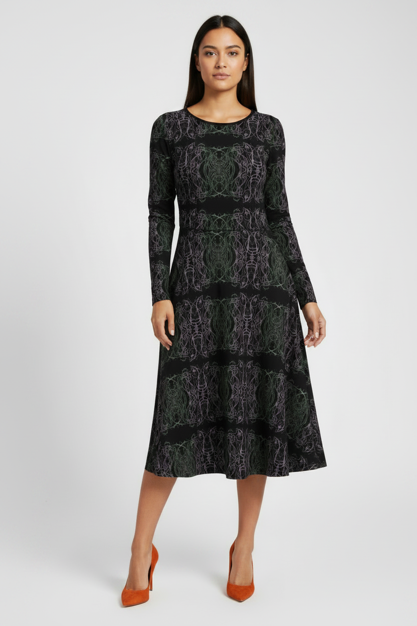 Woman wearing a black patterned dress on a white background