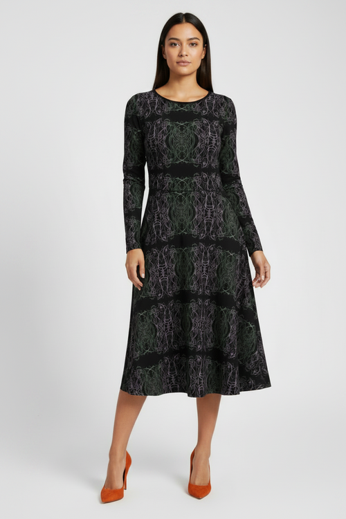 Woman wearing a black patterned dress on a white background