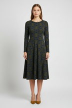 Woman wearing a patterned dress on a white background