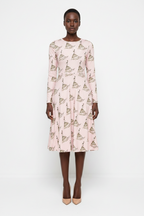 Model wearing a pink dress with geometric pattern on a white background
