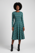 Woman wearing a green patterned dress on a white background