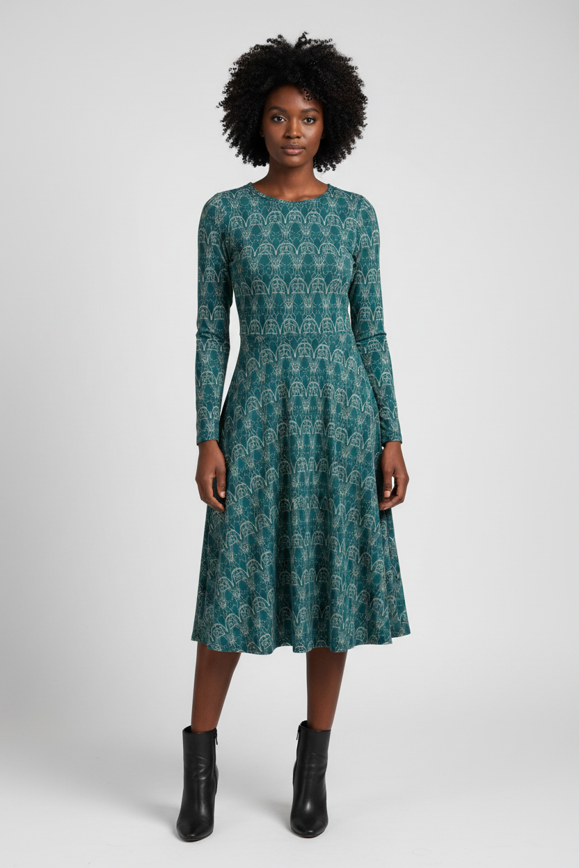 Woman wearing a green patterned dress on a white background