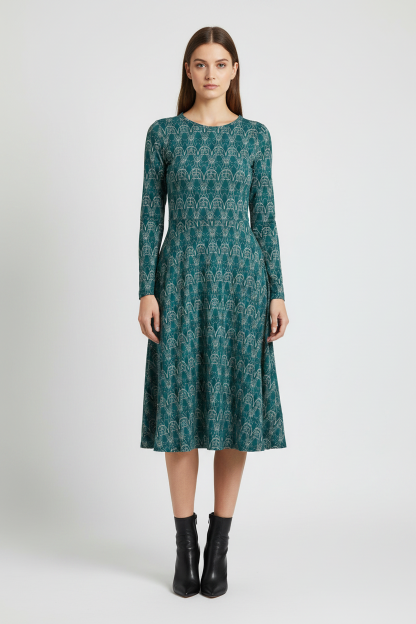 Woman wearing a green patterned dress on a white background