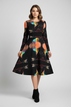 Woman wearing a black dress with colorful abstract patterns on a white background