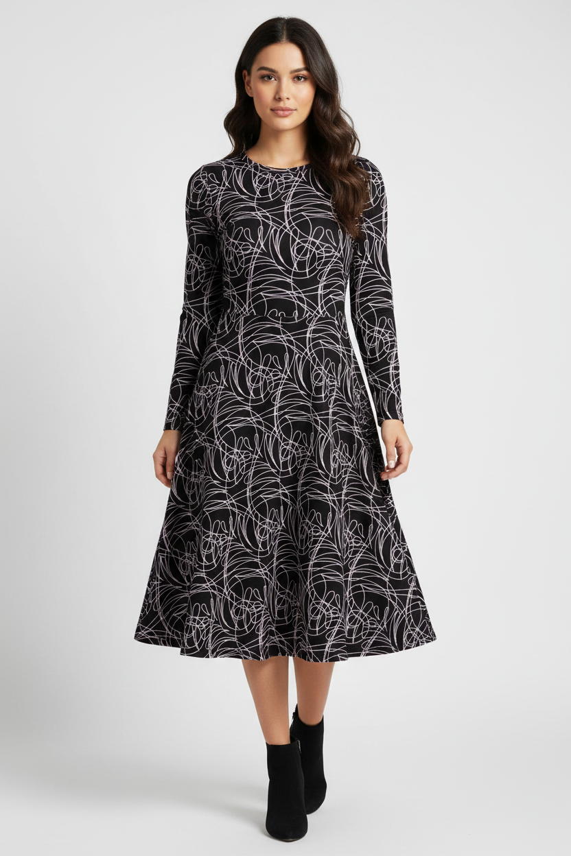 Woman wearing a black and white patterned dress on a white background