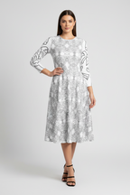 Woman wearing a patterned dress on a white background