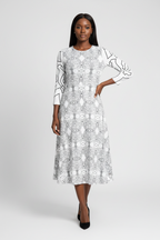 Woman wearing a black and white patterned dress on a white background