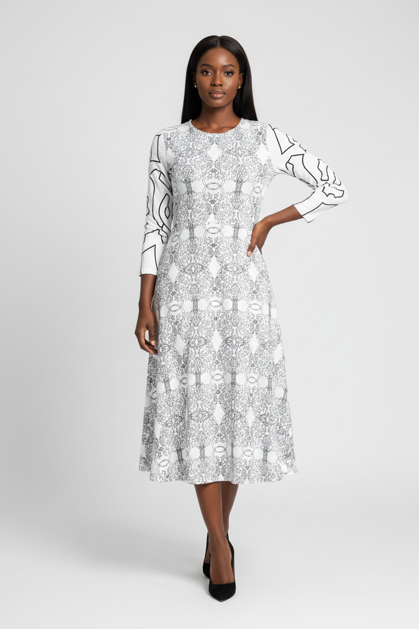 Woman wearing a black and white patterned dress on a white background