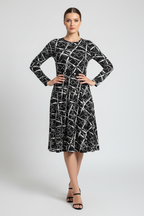 Woman wearing a black and white patterned dress on a white background