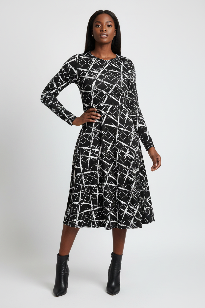 Woman wearing a black and white patterned dress on a white background