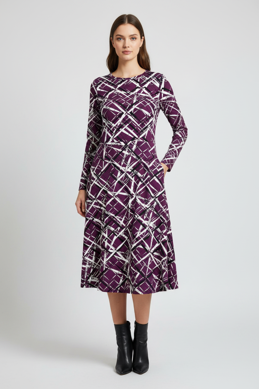 Woman wearing a purple patterned dress on a white background