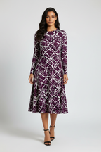 Woman wearing a purple patterned dress on a white background