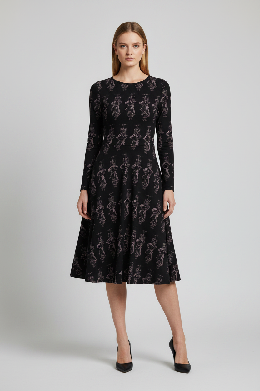 A woman stands against a light gray studio background wearing a long-sleeve black midi dress with an allover tonal floral pattern and black pointed heels.