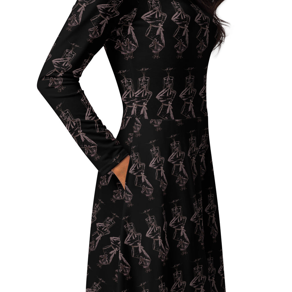 A long-sleeve black dress with an allover pink line-art print of cartoon characters, shown on a model against a white background.