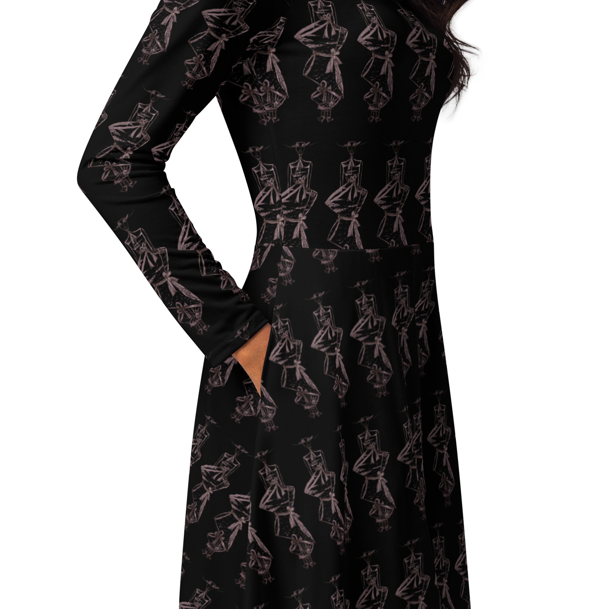 A long-sleeve black dress with an allover pink line-art print of cartoon characters, shown on a model against a white background.