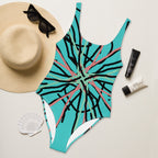 anding confidently in a vibrant abstract line print one-piece swimsuit.

Close-up of the swimsuit's top, showing the scoop neckline and dynamic abstract design.