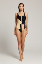 Woman wearing a geometric patterned swimsuit on a plain background