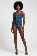 Model wearing a blue swimsuit with a pattern on a white background