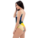 Side profile of a woman wearing the abstract geometric print one-piece swimsuit.