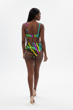 Woman wearing a colorful striped swimsuit on a white background