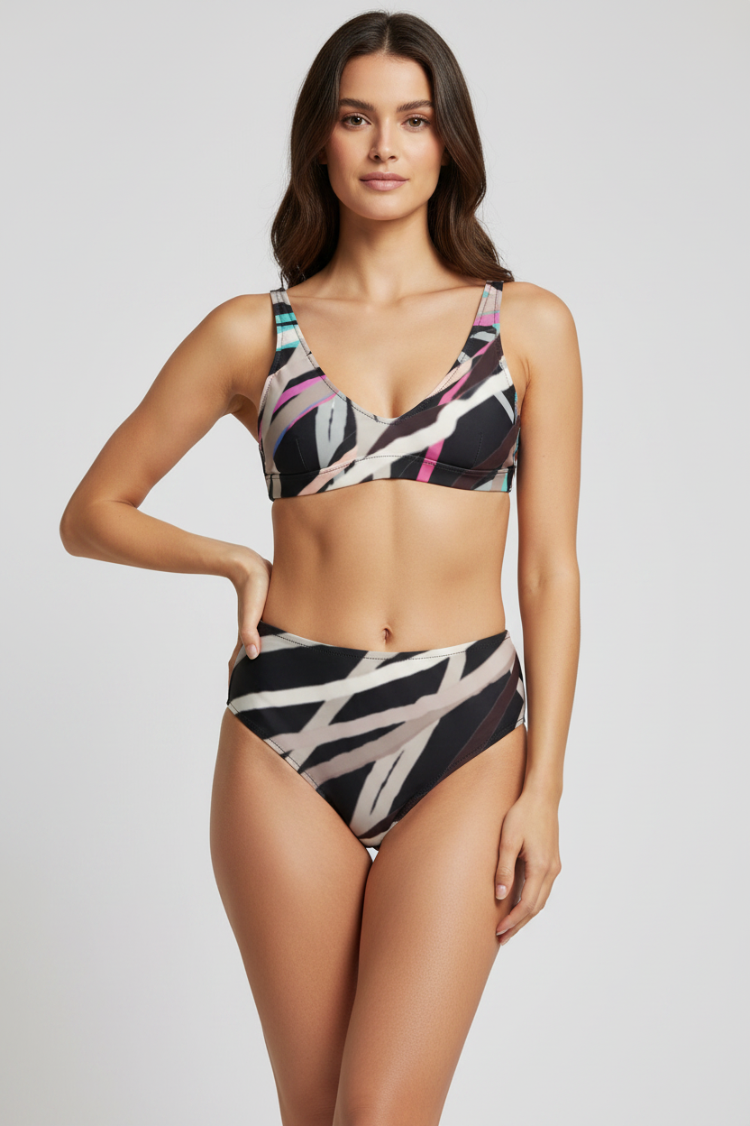 Woman wearing a patterned swimsuit on a plain background