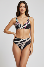 Woman wearing a patterned swimsuit on a plain background